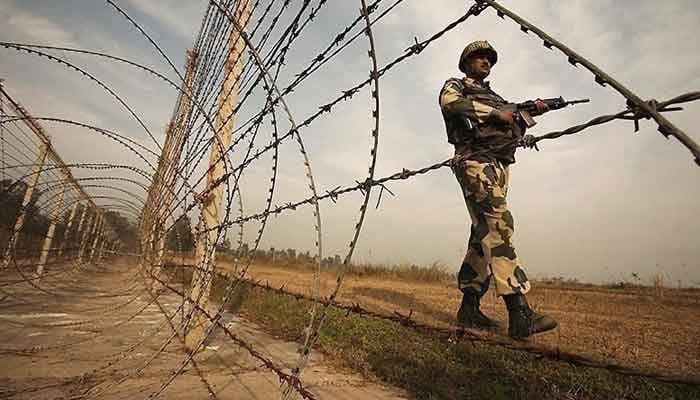 You can see a standing Indian soldier next to a spike wire on the control line. —Reuters/file