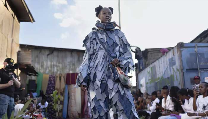 Models wear outfits created by local fashion designers specializing in recycling discarded fabrics and garments from second-hand clothing markets. — AFP