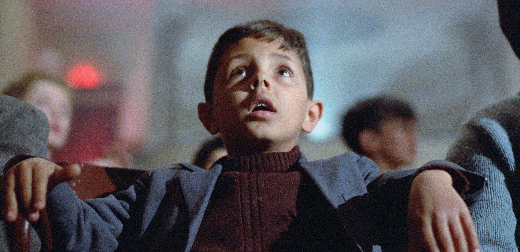 Salvatore Cascio as a child sitting in front of a movie screen