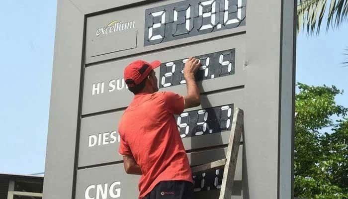 A representative image of a fuel station employee updating fuel prices in Karachi. — AFP/Archive