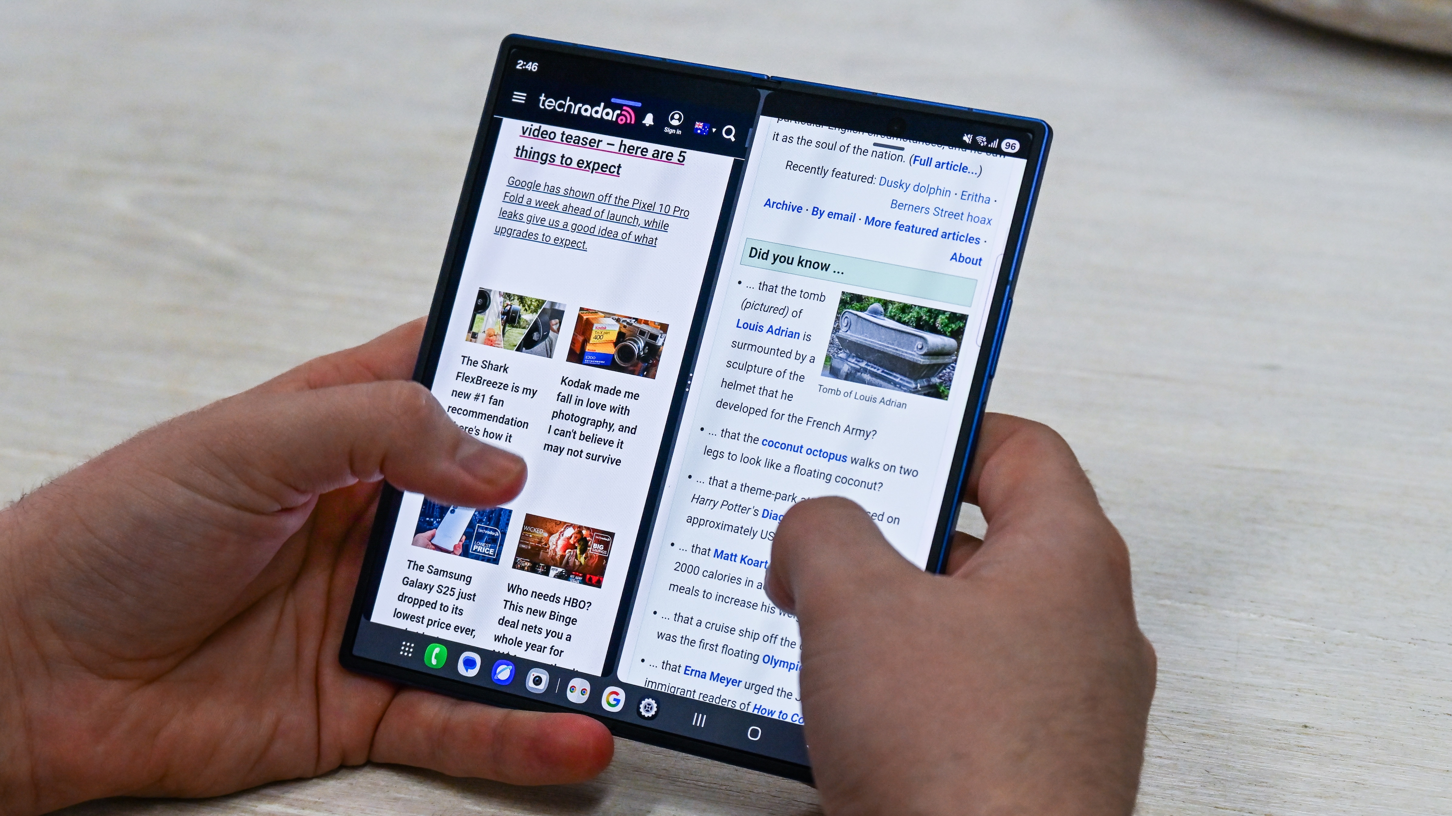 Someone who uses the Samsung Galaxy Z Fold 7 when it unfolds, with two open web browsers at the same time.