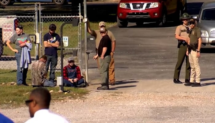 Law enforcement officers guard a door outside the Accurate Energetic Systems military explosives plant, following an explosion at the facility in Bucksnort, Tennessee, U.S., Oct. 10, 2025, in a still image from video. – Reuters