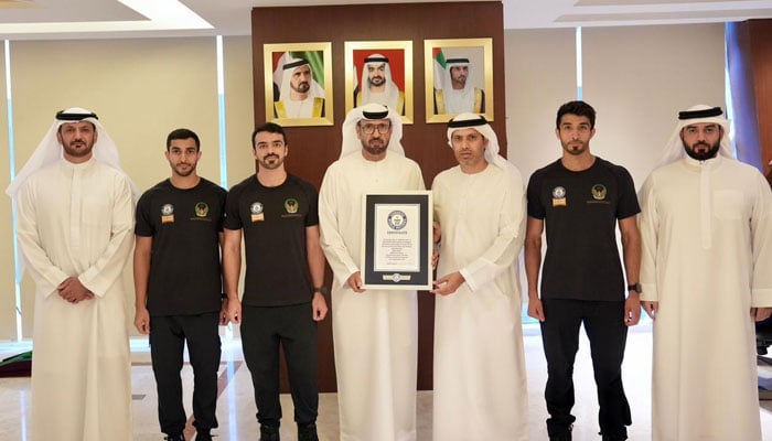 Dubai Civil Defense firefighters receive the Guinness World Record certificate after completing the fastest ascent of the Burj Khalifa. — Civil Defense/Dubai Archive