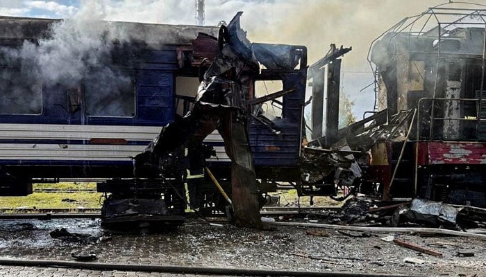 The smoke rises on a passenger train run over by the strike of Russian unmanned aircraft today, in the middle of Russias Attack against Ukraine, at the railway station in the city of Shostka, Sumy region, Ukraine, October 4, 2025.—