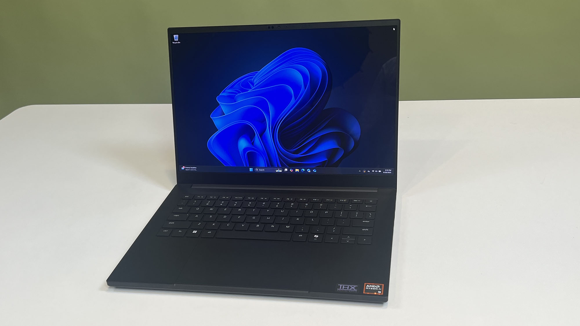 A Razer 14 (2025) blade on a desktop showing the Windows 11 desktop