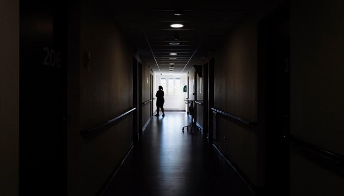 A woman's silhouette is at the end of a dark corridor, reflecting the isolation and heaviness that often feels in depression. –AFP/File