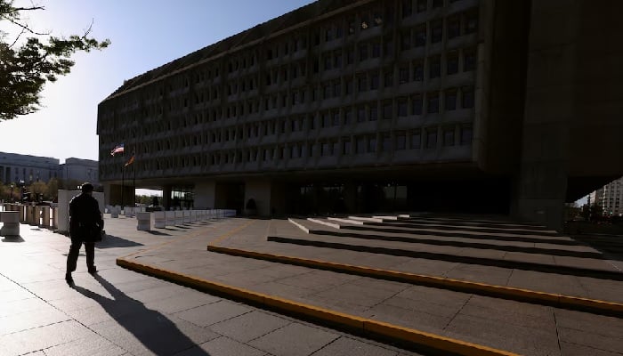 A man casts a shadow as he walks toward the Hubert H. Humphrey Building, headquarters of the Department of Health and Human Services (HHS), in Washington, DC, U.S., April 1, 2025. – Reuters