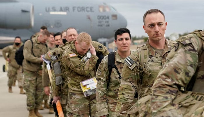 Military personnel from the 82nd Airborne Division and 18th Airborne Corps board a C-17 transport plane for deployment to Eastern Europe, amid rising tensions between Ukraine and Russia, at Fort Bragg, North Carolina, US, on February 3, 2022. – Reuters