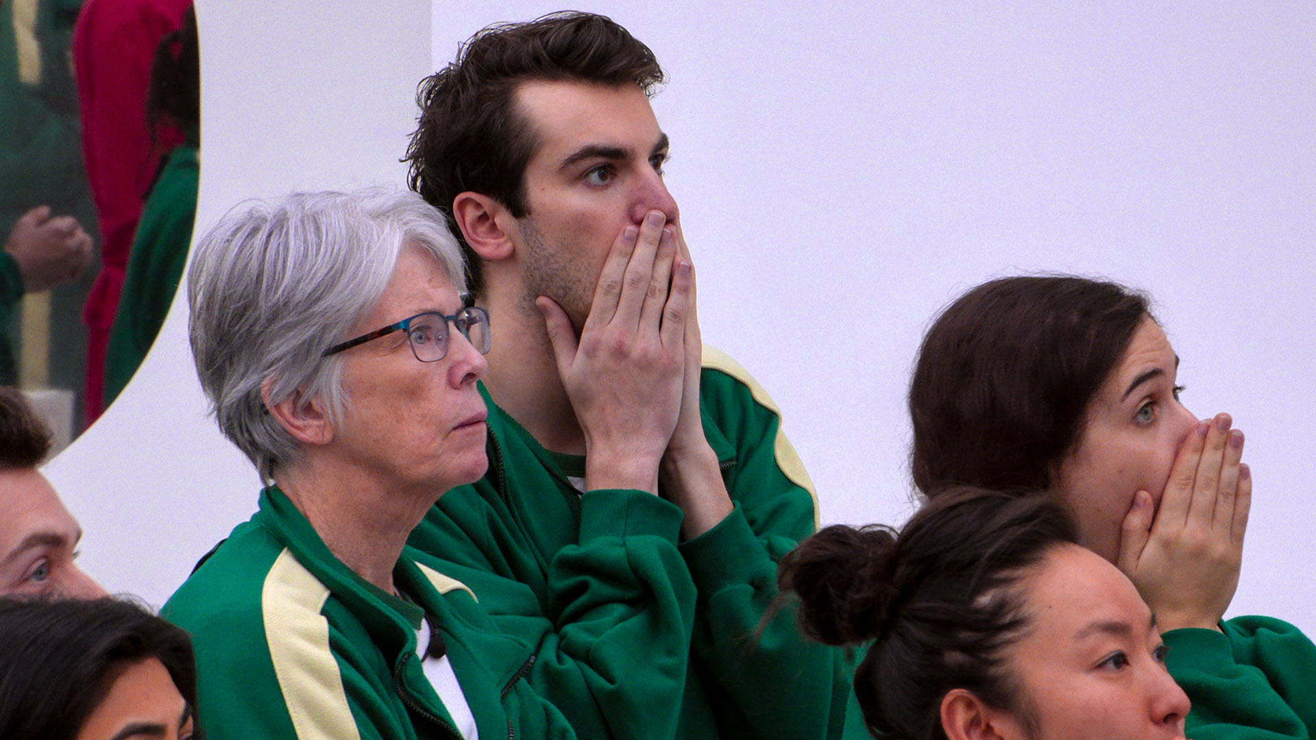 Surprised contestants put their hands in their mouths in Netflix's Squid Game: The Challenge