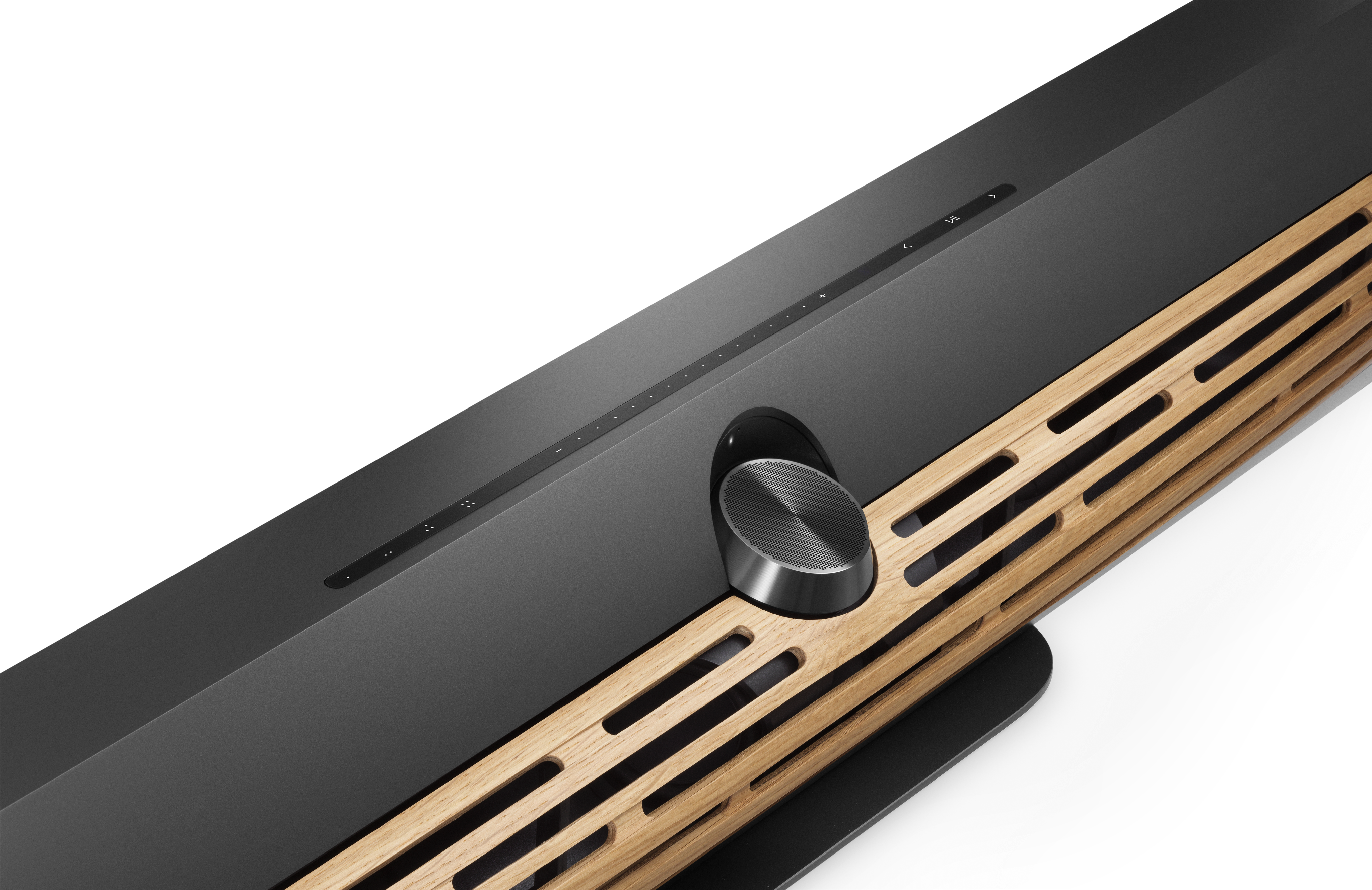 Closeup of the Bang & Olufsen Beosound Premiere in black with wooden grille on white background