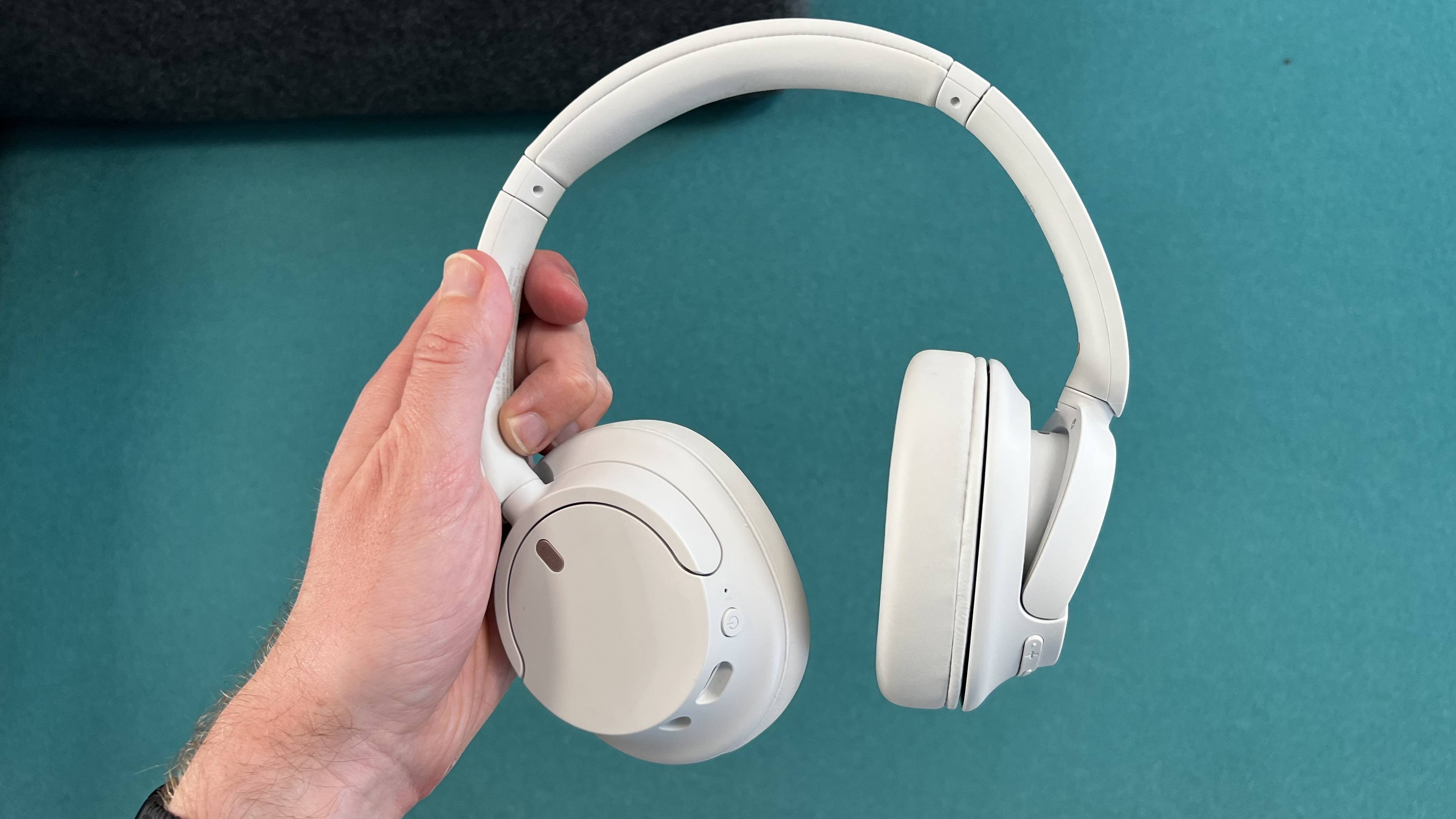 Sony WH-CH720N headphones in one hand