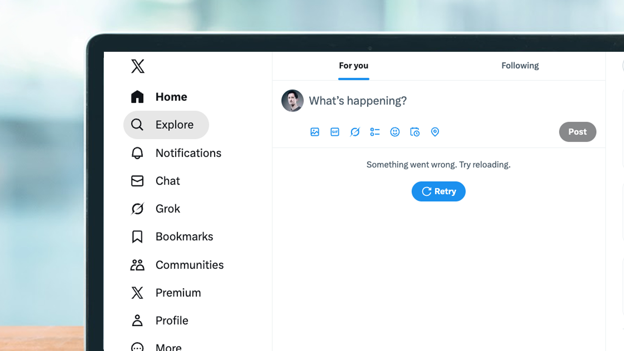 A laptop screen displays an error message in X