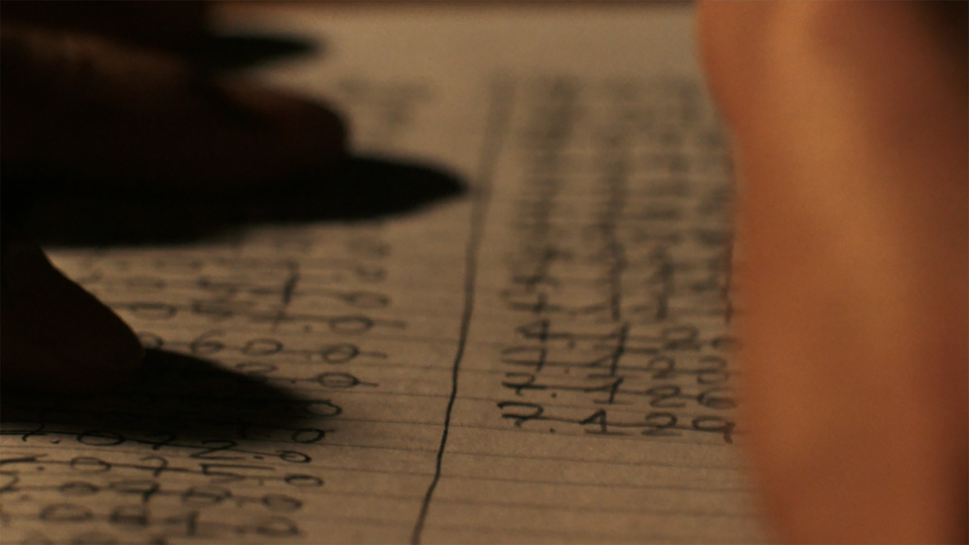 Someone crossing out radio frequencies on a notepad in episode 4 of Pluribus