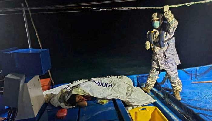 A member of the Malaysian Maritime Enforcement Agency checks on a survivor who was rescued by the crew of a fishing boat after a boat from Buthidaung, Myanmar, sank near the Malaysia-Thailand border, near Langkawi, Malaysia, November 9, 2025.— Reuters