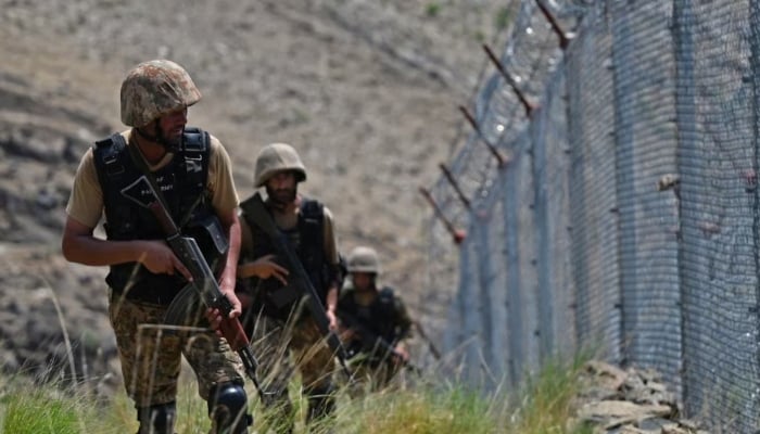 Pakistani troops patrol along the border fence between Pakistan and Afghanistan in the Khyber district of Khyber Pakhtunkhwa. — AFP/Archive