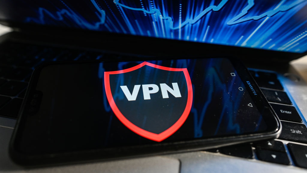 A VPN runs on a mobile phone placed on the keyboard of a laptop