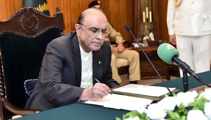 President Asif Ali Zardari signs a bill in this undated image. — President's House