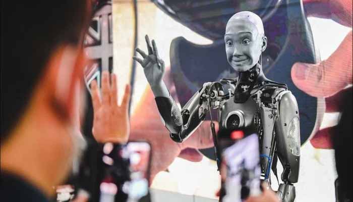 This representative image shows a human-like robot greeting viewers. — AFP/Archive