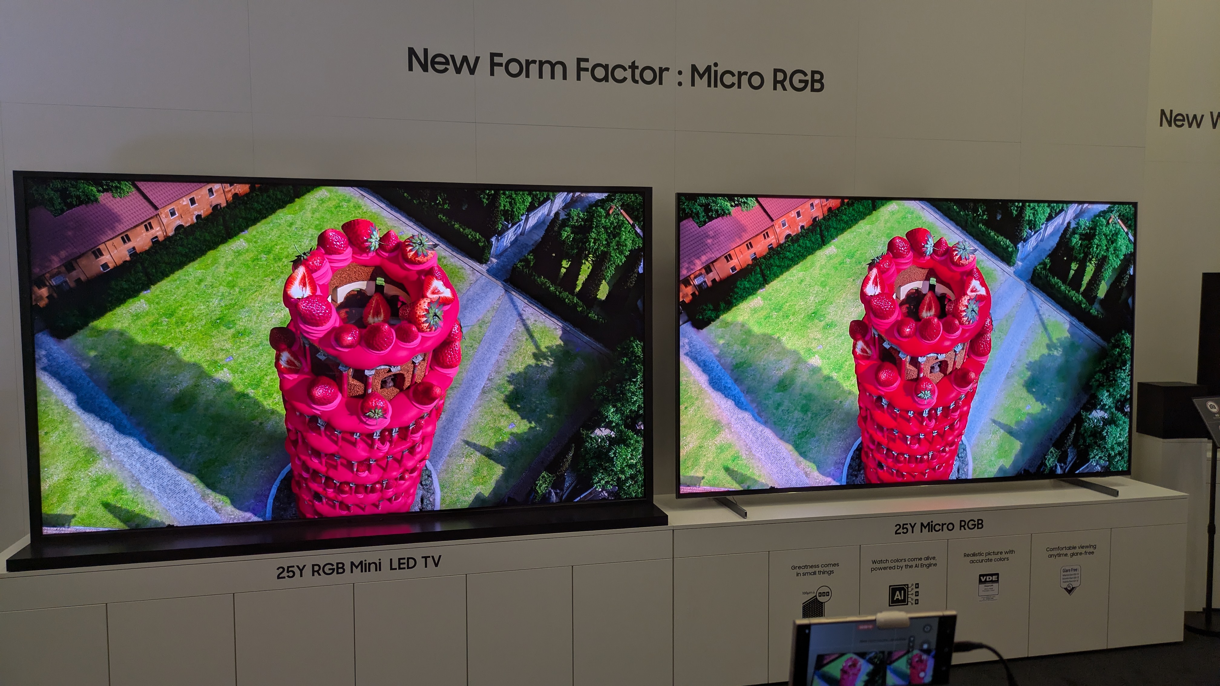 A mini-LED RGB TV (left) next to Samsung's micro-RGB TV showing a red tower