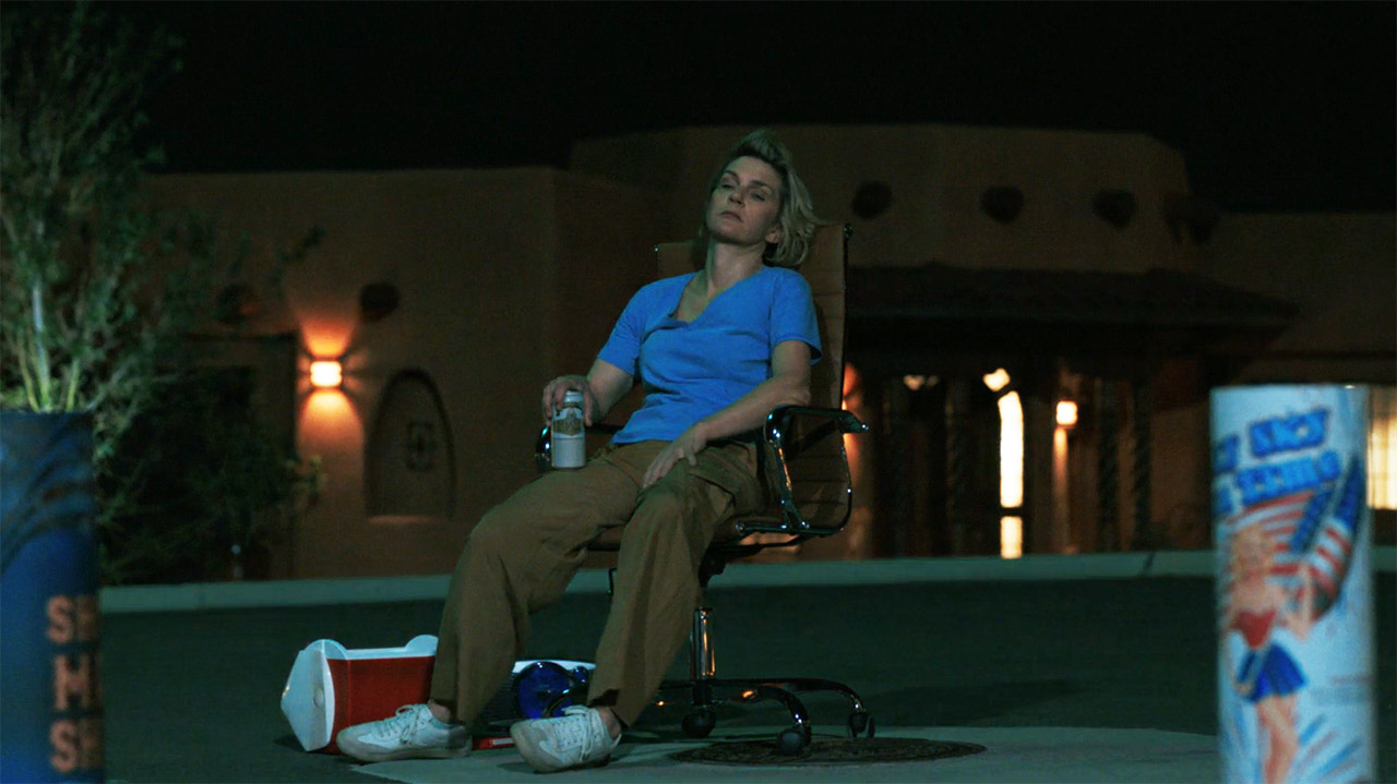 A Carol sitting around watching some fireworks at night in episode 7 of Pluribus.