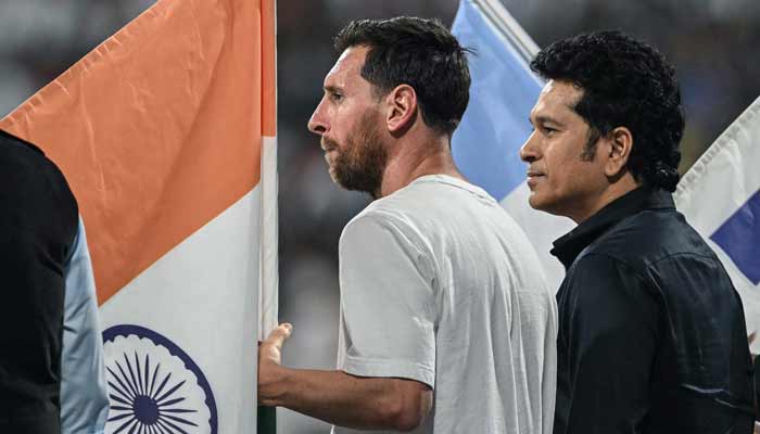 Argentine footballer Lionel Messi (L) and former Indian cricketer Sachin Tendulkar attend an event during the Messis Goat Tour at the Wankhede Stadium in Mumbai on December 14, 2025. – AFP