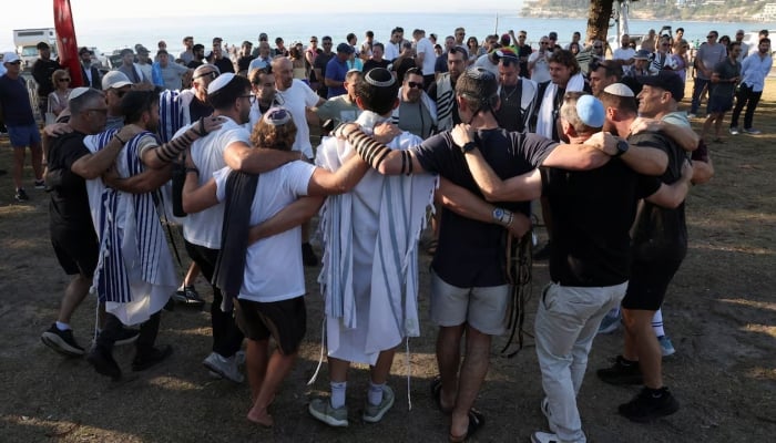 Members of the Jewish community gather for Shacharit, morning prayers, as the crime scene reopened following the mass shooting at Bondi Beach on Sunday, in Sydney, Australia, December 19, 2025. – Reuters