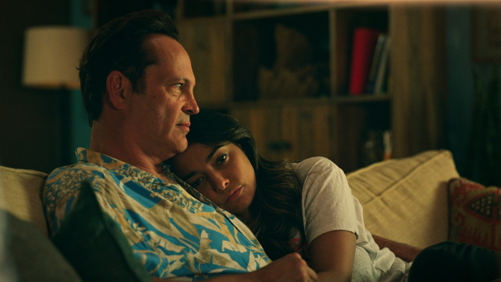 Yancy and Rosa hug on a couch in Bad Monkey