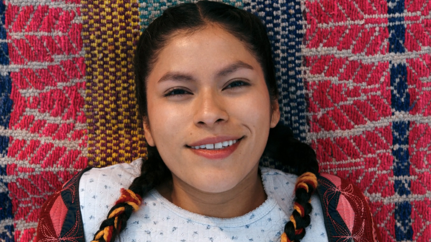 Kusimayu smiling after being converted to join The Others in episode 9 of Pluribus