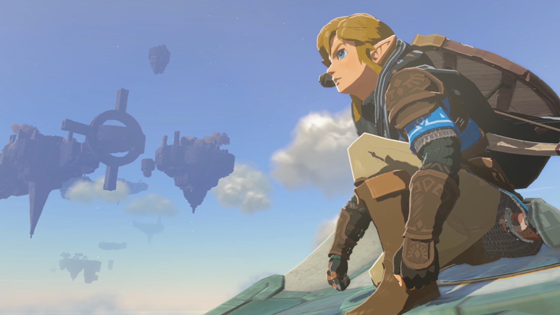 Link crouches, looking towards Hyrule. A light blue island can be seen floating in the background.