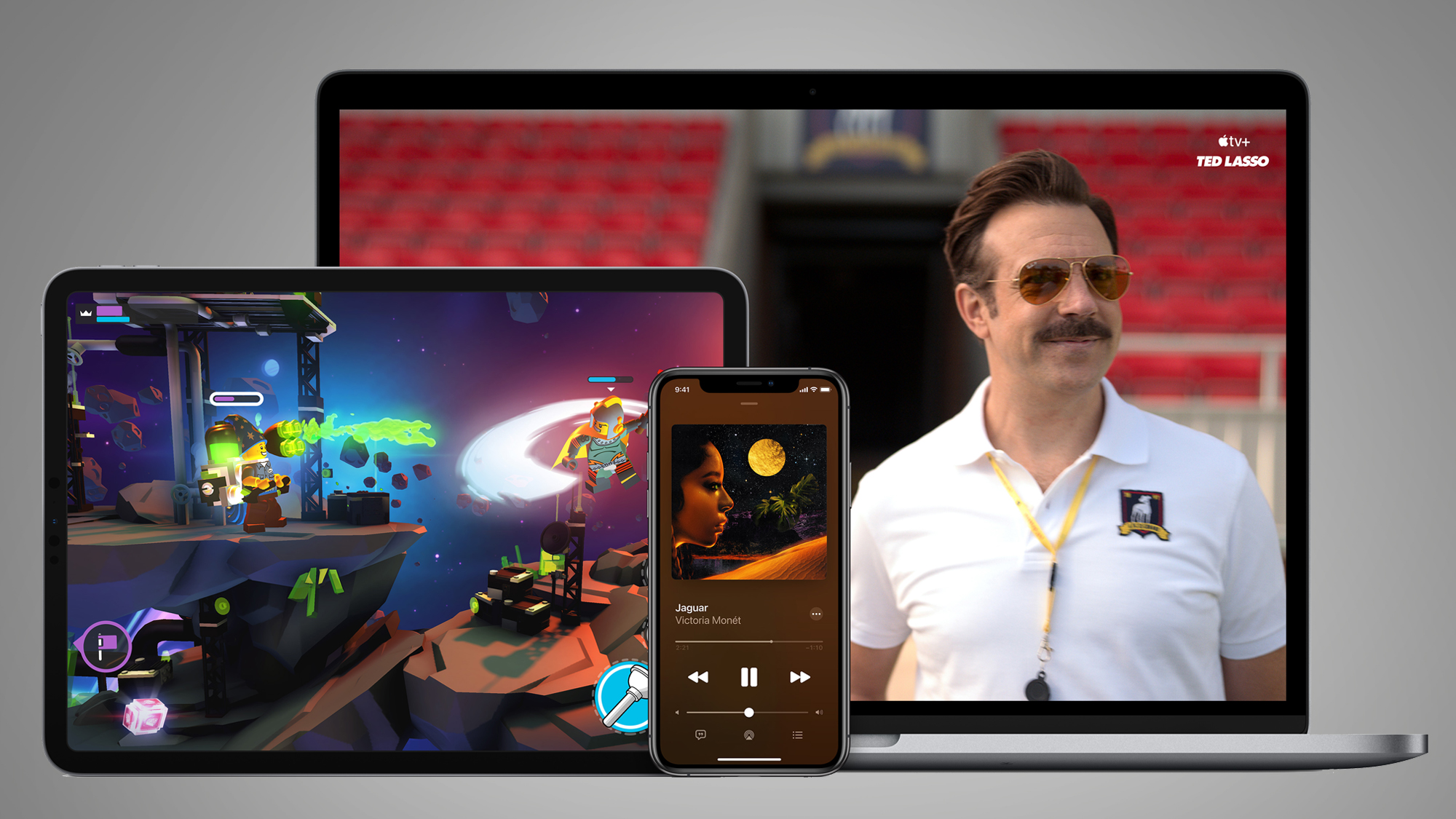 An iPad, an iPhone and a MacBook laptop on a gray background