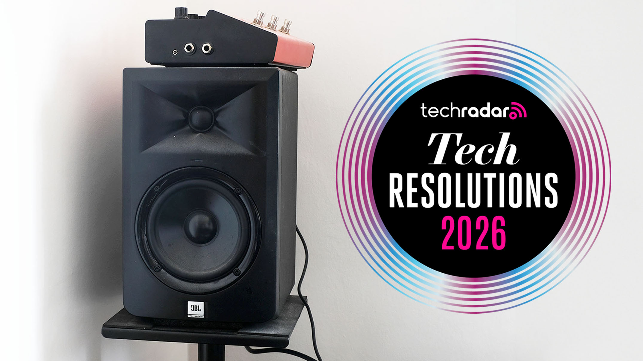 A JBL speaker in a white room next to the technology resolutions logo