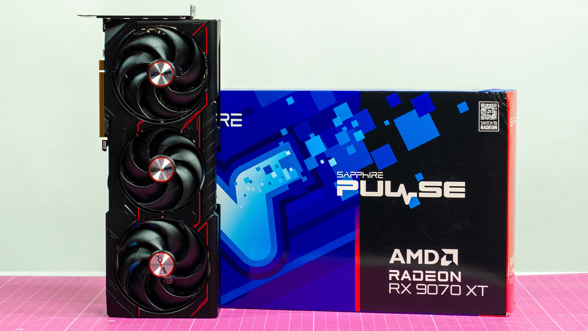 An AMD Radeon RX 9070 XT manufactured by Sapphire on a table in its retail packaging