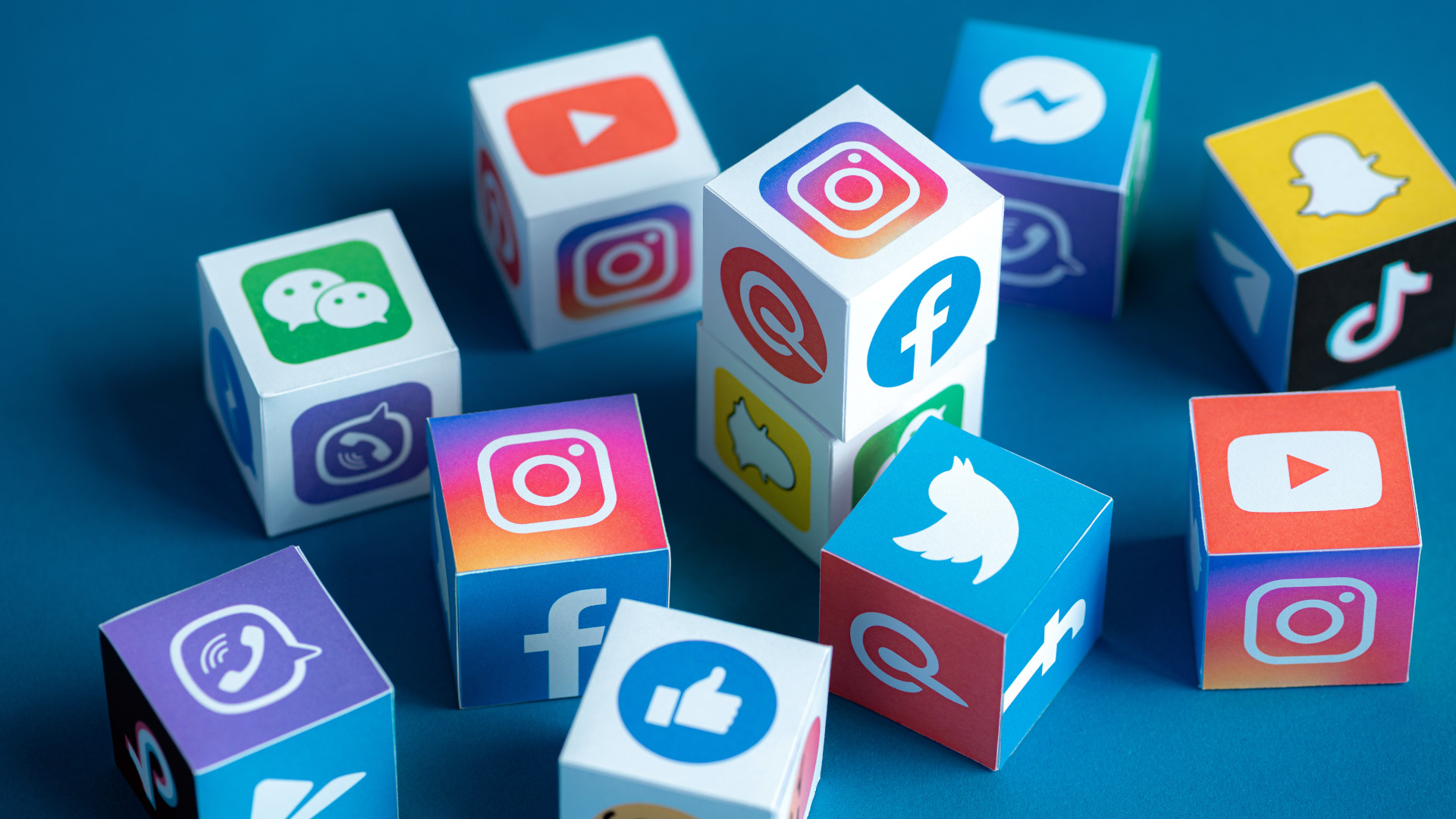 A group of cubes displaying social media logos.