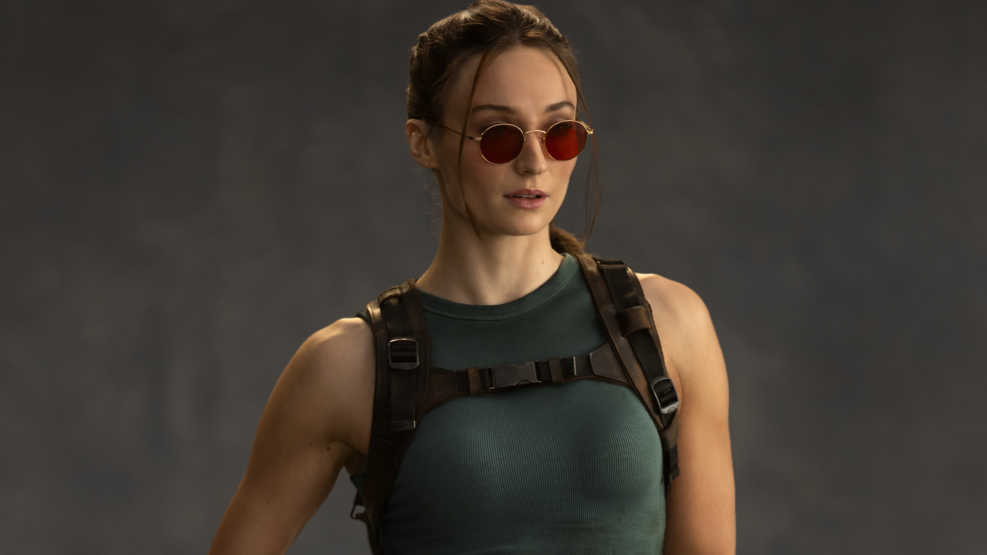 A professional image of Sophie Turner wearing Lara Croft's classic outfit from the Prime Video TV show Tomb Raider.