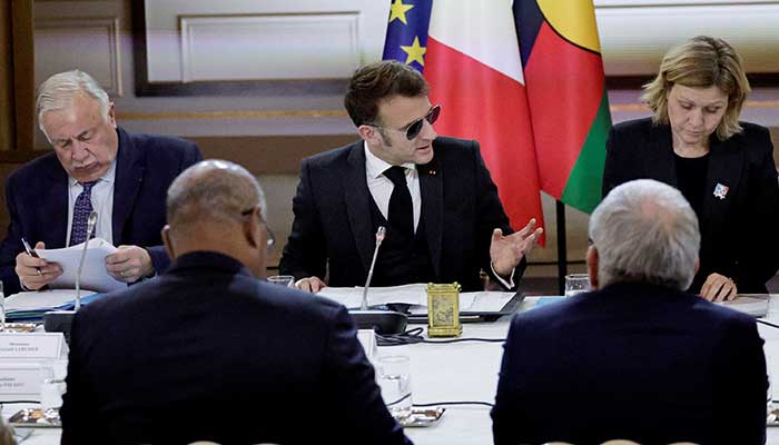French President Emmanuel Macron, flanked by National Assembly Speaker Yael Braun-Pivet and Senate President Gerard Larcher, gestures as he addresses a meeting on New Caledonia at the Elysee Palace in Paris, France, January 19, 2026. – Reuters