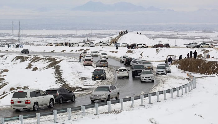 Commuters drive on a snow-covered road in Chaman, Khyber Pakhtunkhwa, on January 22, 2026. — AFP