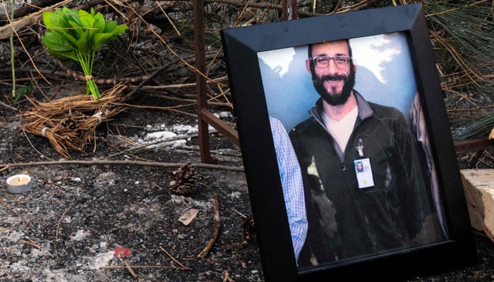 A photograph of Alex Pretti, 37, can be seen at a makeshift memorial in the area where he was shot and killed by federal immigration agents earlier that day in Minneapolis, Minnesota, on January 24, 2026. — AFP