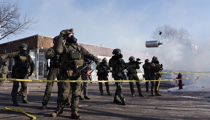 A federal agent throws a canister of tear gas near the scene where a man identified as Alex Pretti was shot and killed by federal agents trying to arrest him, in Minneapolis, Minnesota, USA, on January 24, 2026. — AFP