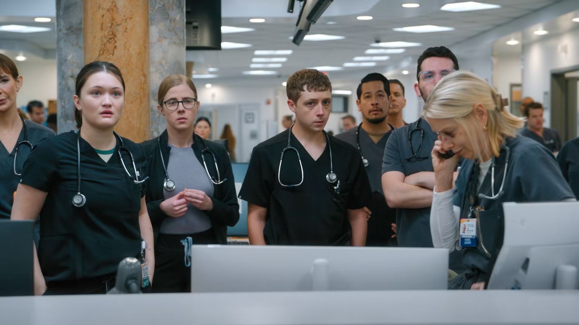 The cast of The Pitt watches something off screen.