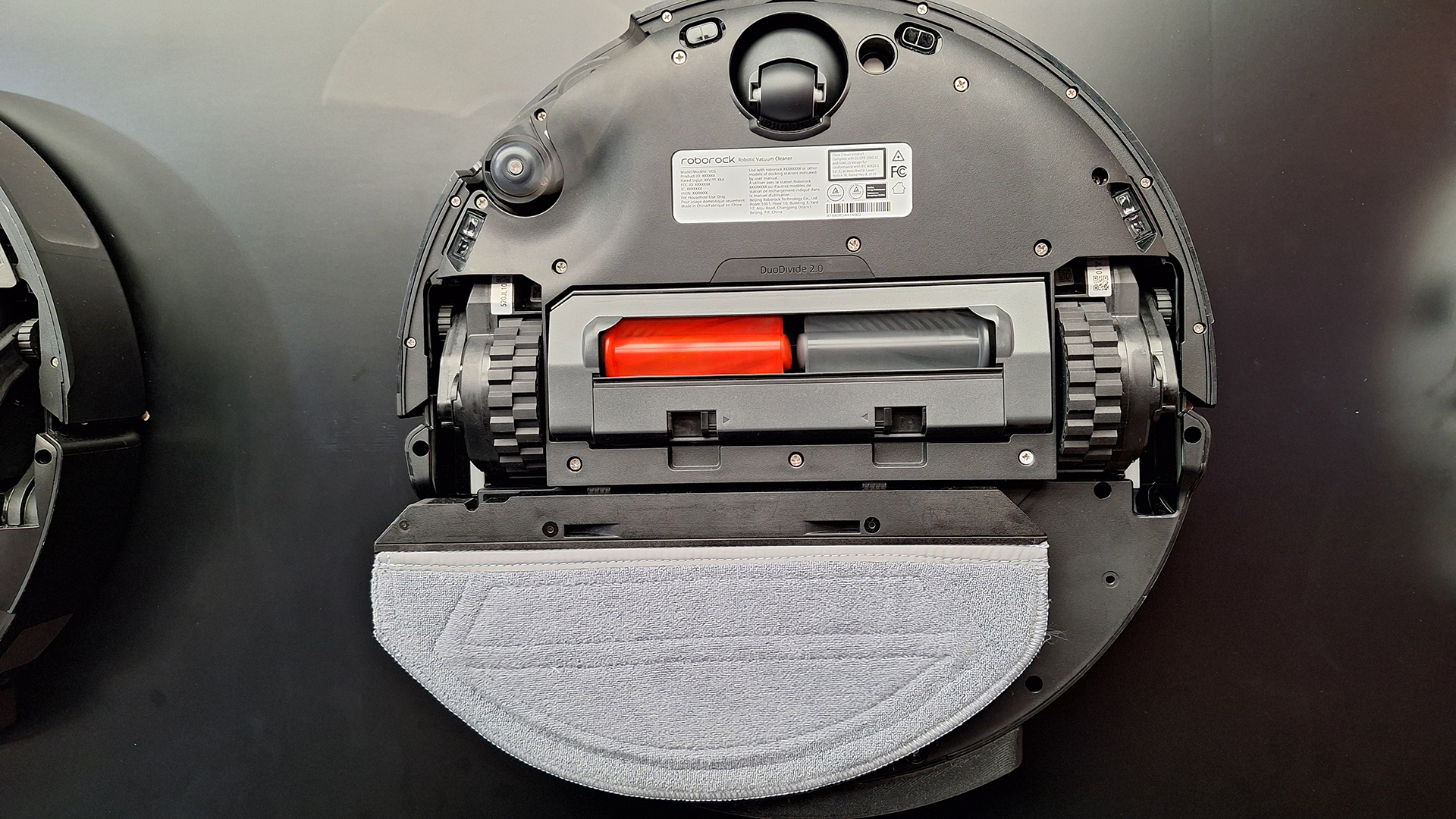 Roborock Saros 20 Sonic robot vacuum cleaner flipped over to reveal mopping system underneath