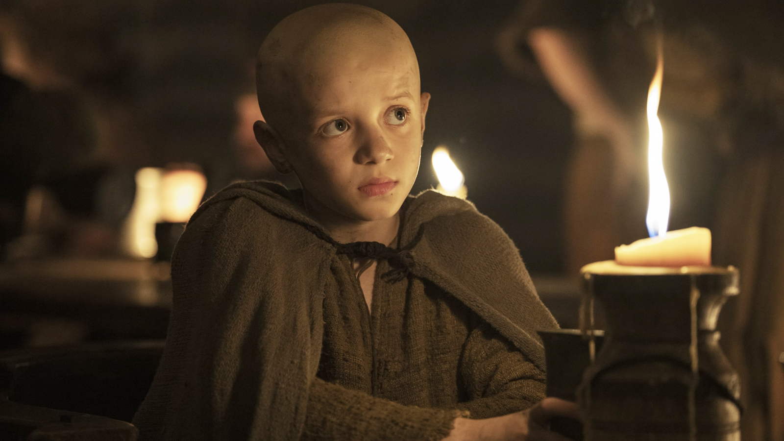 Egg sitting in a dark tent next to a lit candle in episode 2 of A Knight of the Seven Kingdoms