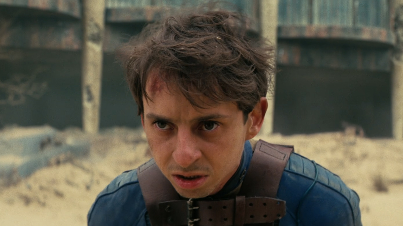 A close-up of a bloodied Norm in Fallout Season 2, Episode 8