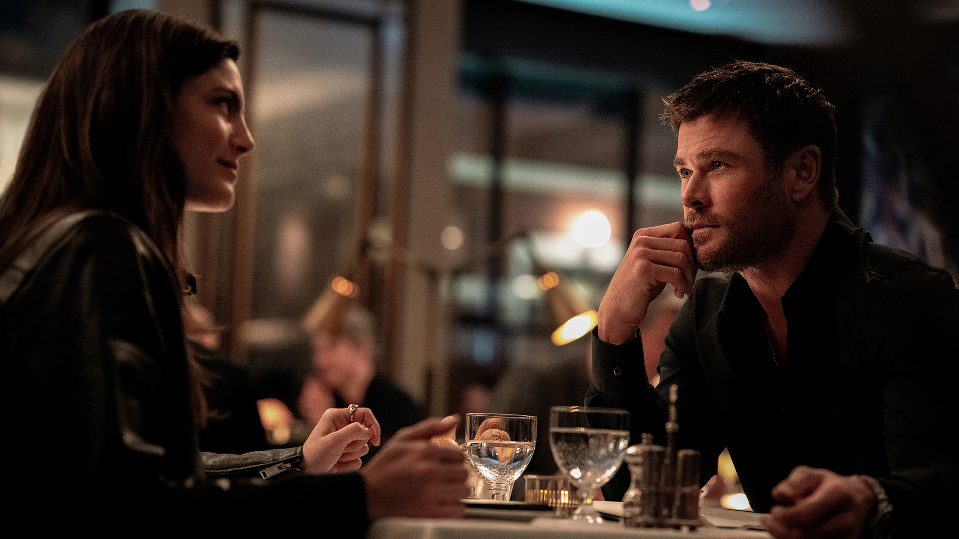 Maya sitting across from Davis on date night on Crime 101