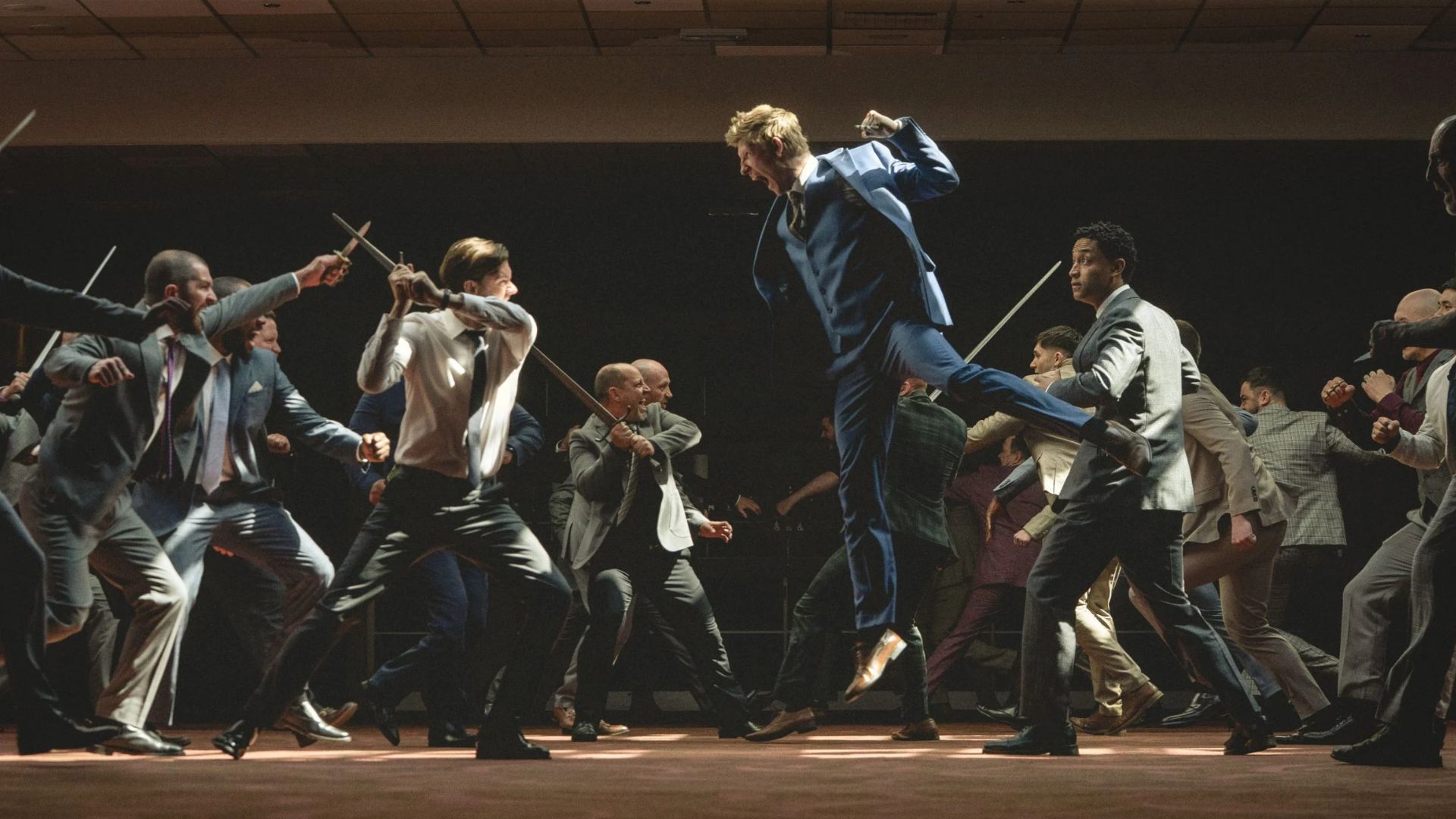 Two groups of boys lunge at each other with swords.