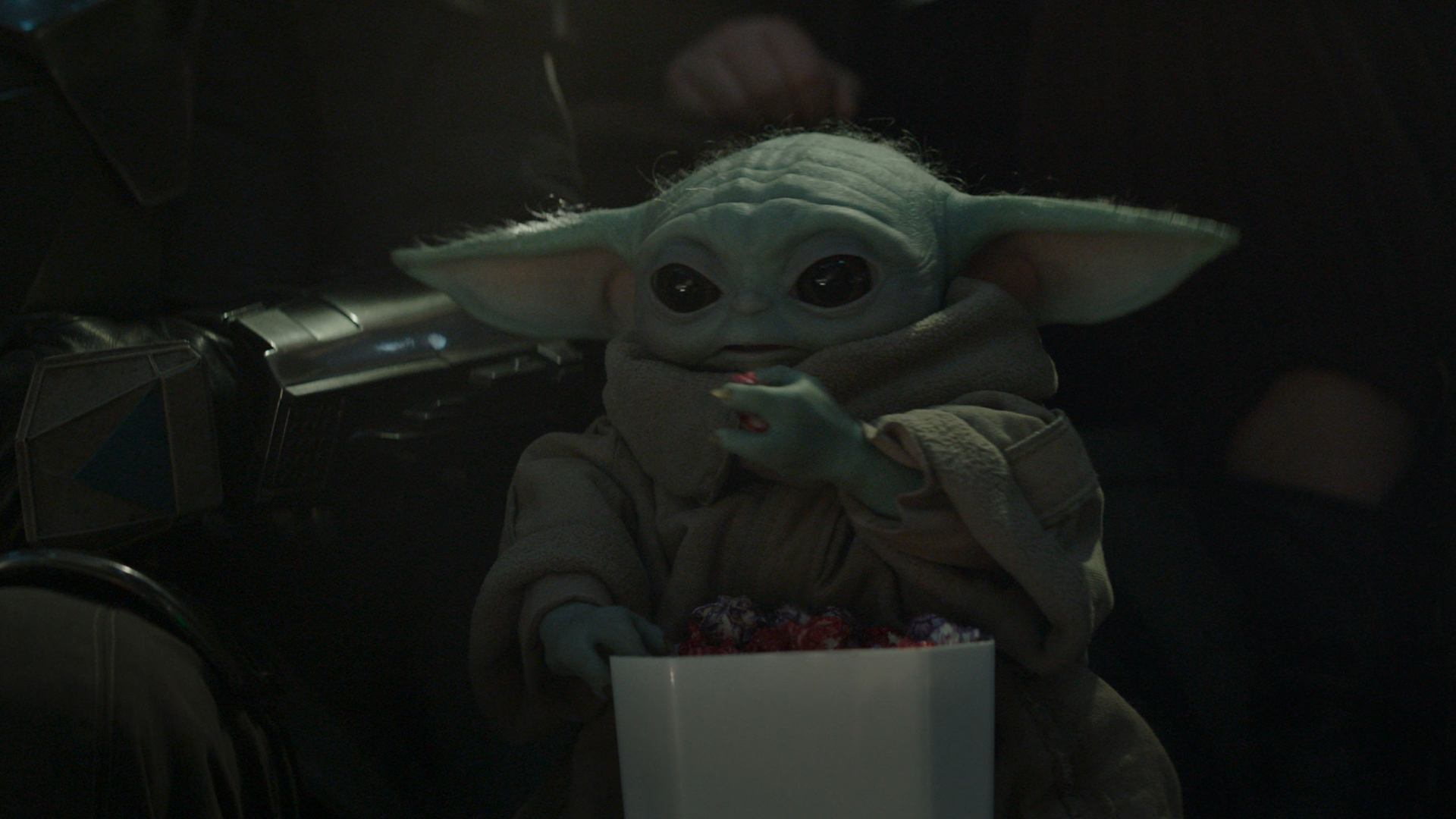 Baby Yoda eating a snack in The Mandalorian and Grogu