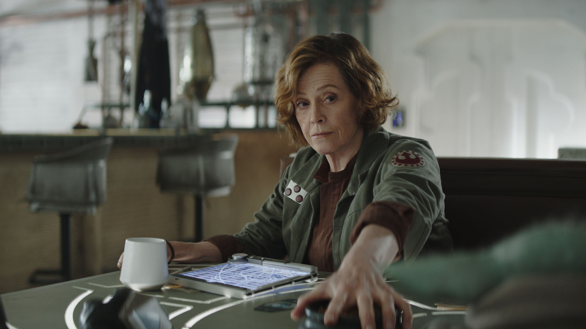 Colonel Ward stops Grogu from stealing his snacks in The Mandalorian and Grogu