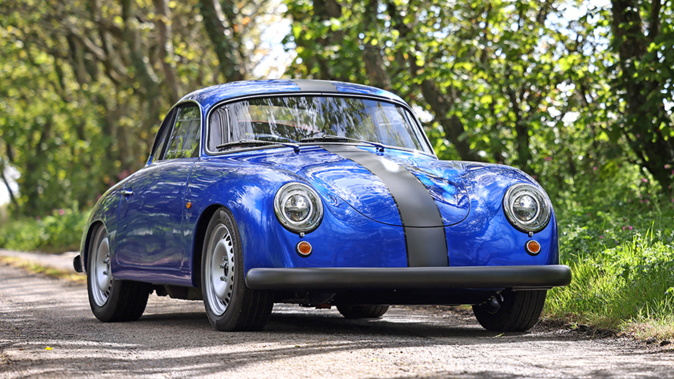 The Watt Electric WEVC ultralight electric coupe parked on a highway