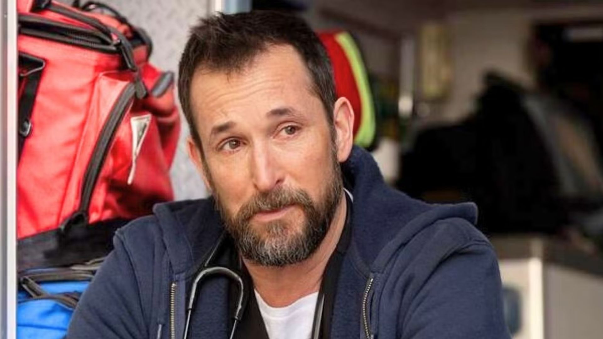 Dr. Robby cries sitting in the back of an ambulance