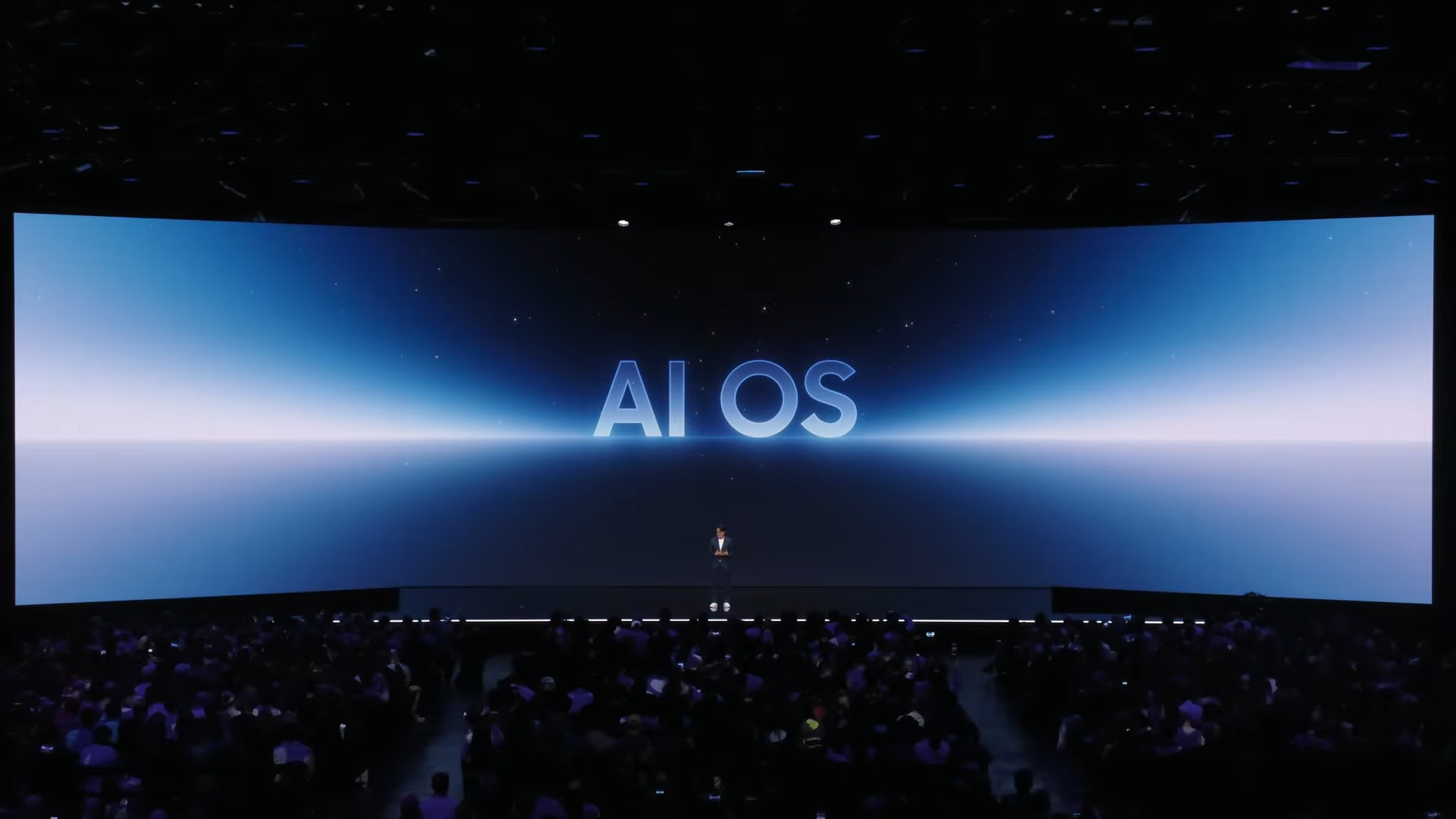 A man on stage at Samsung Galaxy Unpacked talking about AI OS