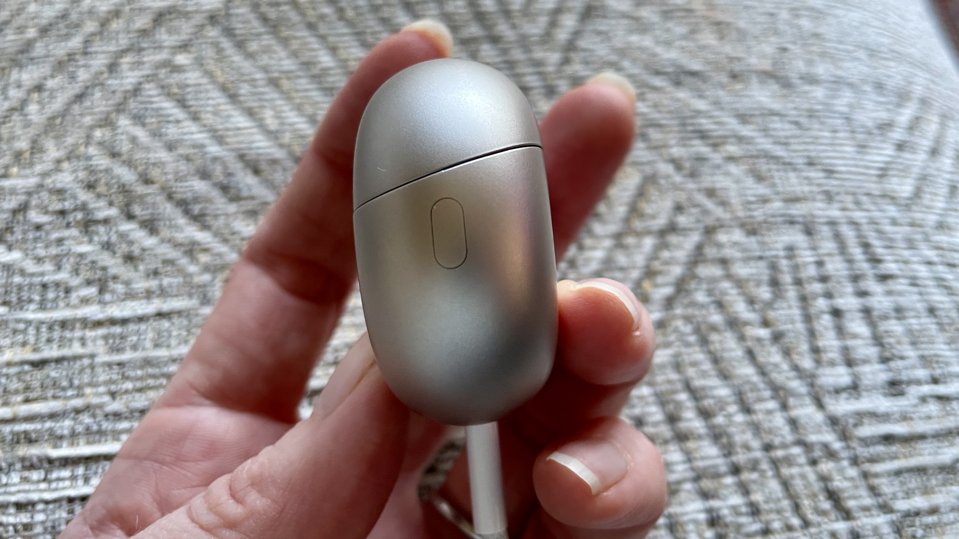 Huawei FreeBuds Pro 5 outside, near some daffodils, in the afternoon sun